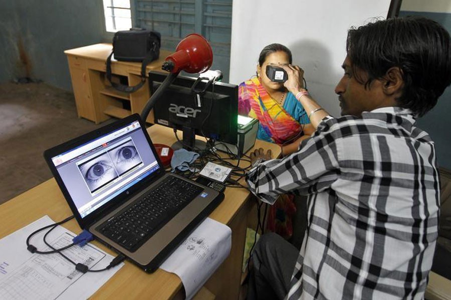 A woman goes through the process of eye scanning for Unique Identification (UID) database system in the outskirts of the western Indian city of Ahmedabad February 13, 2013 – Reuters