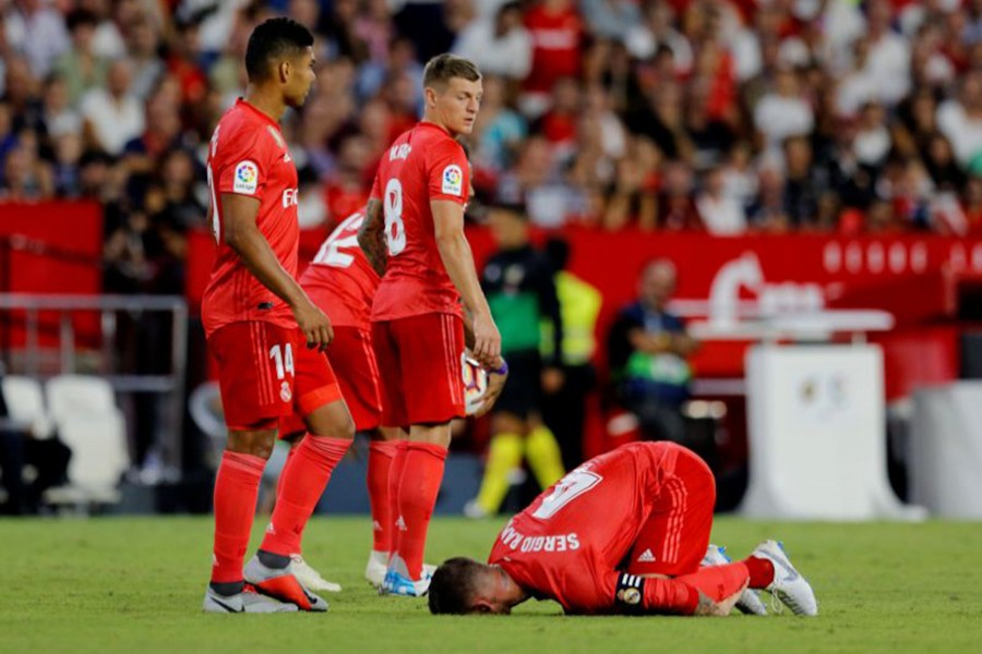 Real Madrid's Sergio Ramos lies on the field after a foul during the encounter against Sevilla — Reuters photo