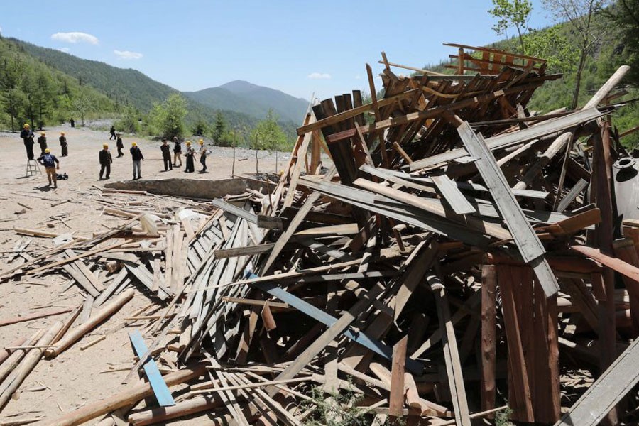 Journalists and North Korean officials look around the dismantled site at the Punggye-ri nuclear test facility – Reuters photo