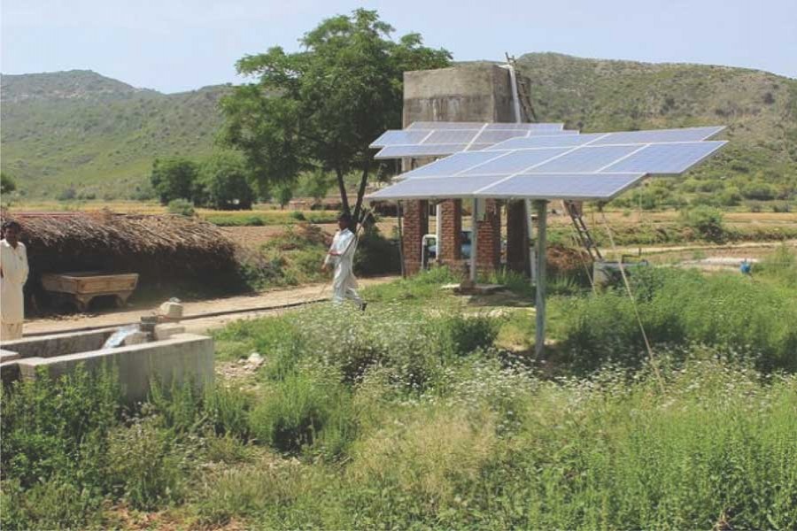 A farmer walks past the solar panels used to pump water in the Soan Valley. The Global Green Growth Institute (GGGI) works closely with countries to diversify their economies, promote solar energies, and connect financial investors with specific green growth projects. 	— Zofeen Ebrahim/IPS