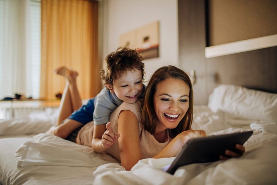 Close up photo of a mother and son using a digital tablet. Internet photo