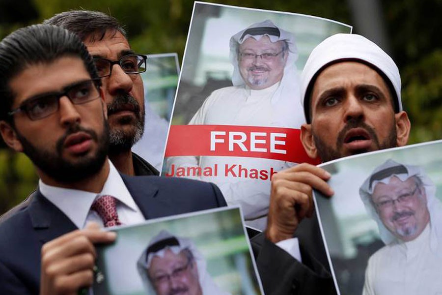 Human rights activists and friends of Saudi journalist Jamal Khashoggi hold his pictures during a protest outside the Saudi Consulate in Istanbul, Turkey October 8, 2018 - Reuters File Photo