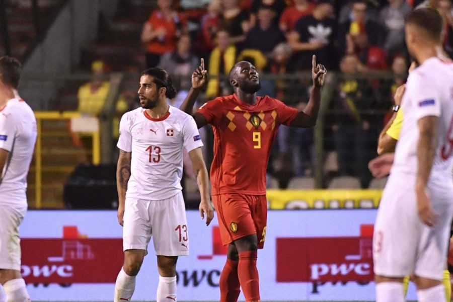 Belgium's Romelu Lukaku, background celebrates after scoring his side's first goal during the UEFA Nations League soccer match between Belgium and Switzerland - AP