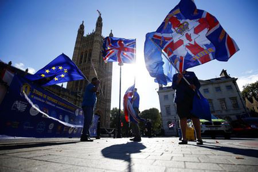Anti-brexit protestors wave flags outside the Houses of Parliament in London, Britain, October 11, 2018. Reuters/Files