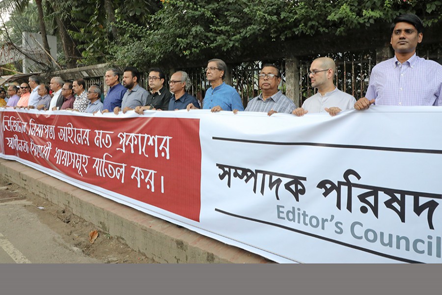 Members of the Editors' Council take part in a human chain  in front of the Jatiya Press Club in  city on Monday demanding amendment to the Digital Security Act. FE Photo