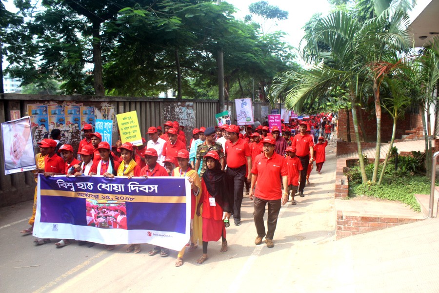 Schoolchildren take out a procession in the capital’s Rayerbazar area on Monday to mark the Global Handwashing Day.