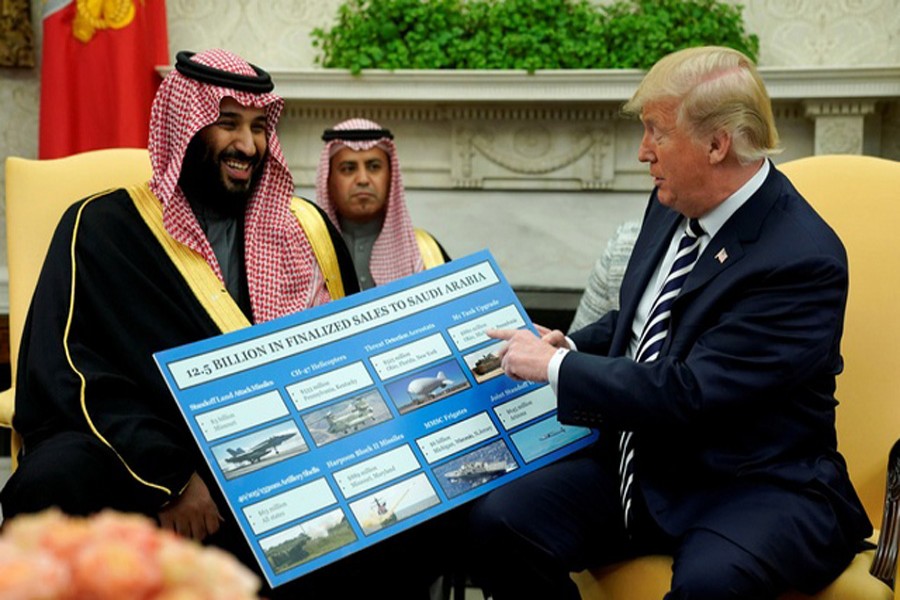 US President Donald Trump holds a chart of military hardware sales as he welcomes Saudi Arabia's Crown Prince Mohammed bin Salman in the Oval Office at the White House in Washington. Reuters