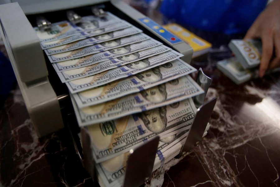 An employee of a bank counts US dollar notes at a branch in Hanoi, Vietnam, May 16, 2016. Reuters