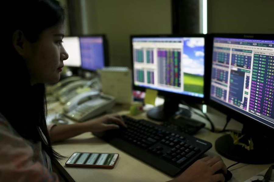 A trader monitors share prices at the Bank Mandiri Sekuritas trading floor in Jakarta August 25, 2015. Reuters/Files
