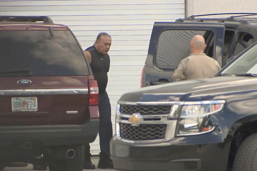 FBI officers escort Cesar Altieri Sayoc into a waiting SUV at FBI headquarters after arresting him in connection with an investigation into a string of parcel bombs in Miramar, Florida, US, October 26, 2018. WSVN Ch. 7/Handout via Reuters