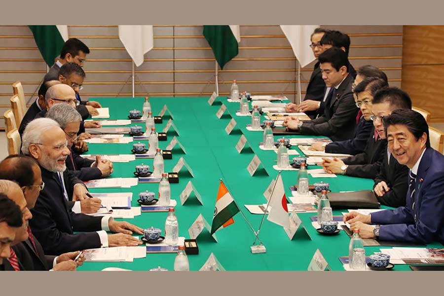 Indian Prime Minister Narendra Modi talking with his Japanese counterpart Shinzo Abe during their meeting at Abe's official residence in Tokyo on Monday. -Reuters Photo