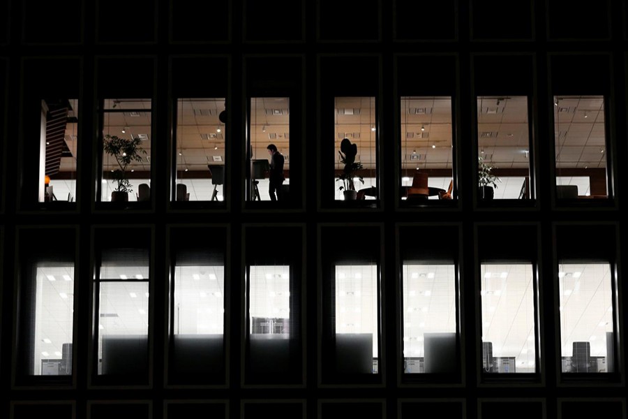 A man is seen at a a commercial building at closing hour at a financial district in Tokyo, Japan on November 22, 2017 — Reuters/File