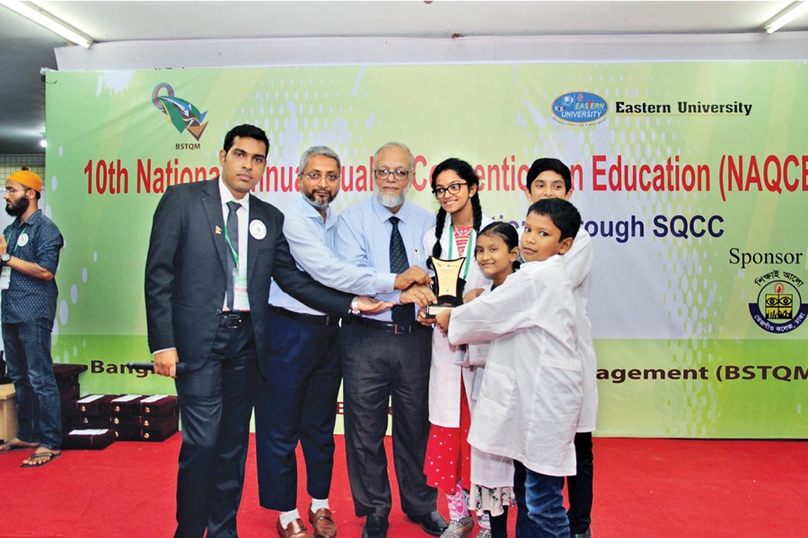 (From left) Master of the ceremony Ather Yeasir Fahim along with convener Md Nuruzzaman Talukder and chief guest Md Abdul Awal, managing director of The Structural Engineers Limited  handing over prize to Upgrade International School team