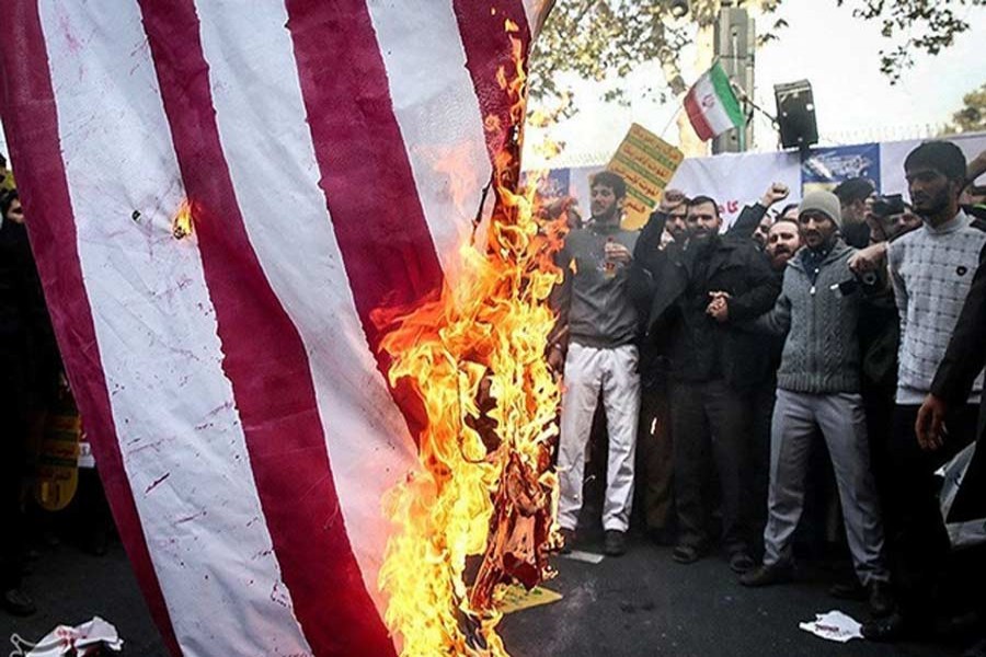 Iranian people burn the US flag as they mark the anniversary of the seizure of the US Embassy, in Tehran, Iran, November 4, 2018. Tasnim News Agency /Handout via Reuters