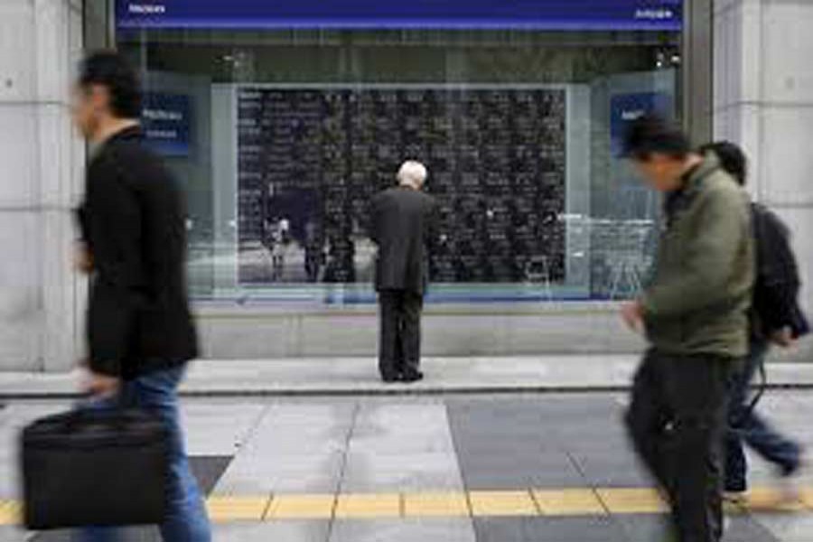 A man looks at a stock quotation board outside a brokerage in Tokyo, Japan, April 18, 2016. Reuters/Files