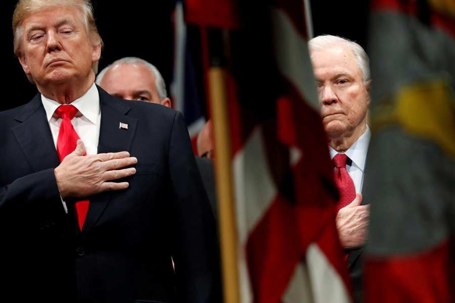 US President Donald Trump and Attorney General Jeff Sessions stand for the national anthem at a graduation ceremony at the FBI Academy on the grounds of Marine Corps Base Quantico in Quantico, Virginia, US, December 15, 2017. Reuters/File Photo