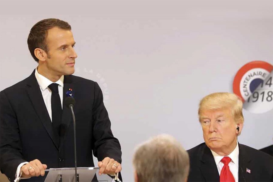 French President Emmanuel Macron delivers a speech while President Donald Trump looks on before a lunch at the Elysee Palace, in Paris, as part of the commemorations marking the 100th anniversary of the 11 November 1918 armistice, ending World War I on November 11:  'Nationalism is a betrayal of patriotism,' says Macron as if  as a rebuke to President Trump — Photo:  AP