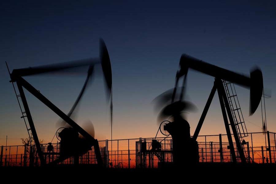 Oil pumps are seen after sunset outside Vaudoy-en-Brie, near Paris, France, November 14, 2018. Reuters/Files