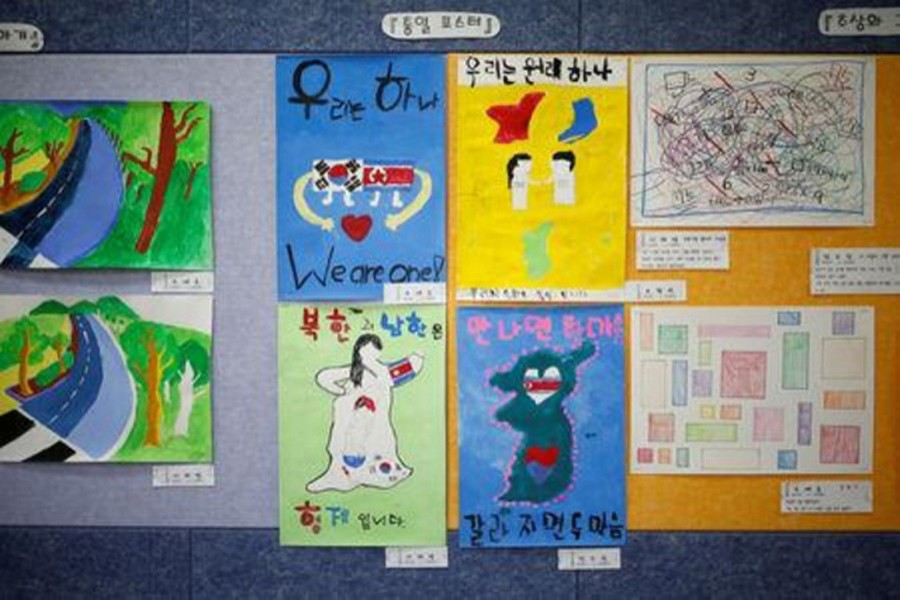 Posters bearing messages, wishing unification between the two Koreas, hang on a wall at the Daesungdong Elementary School, a school inside the demilitarised zone separating the two Koreas, in Paju, South Korea, November 22, 2016. Reuters/File Photo