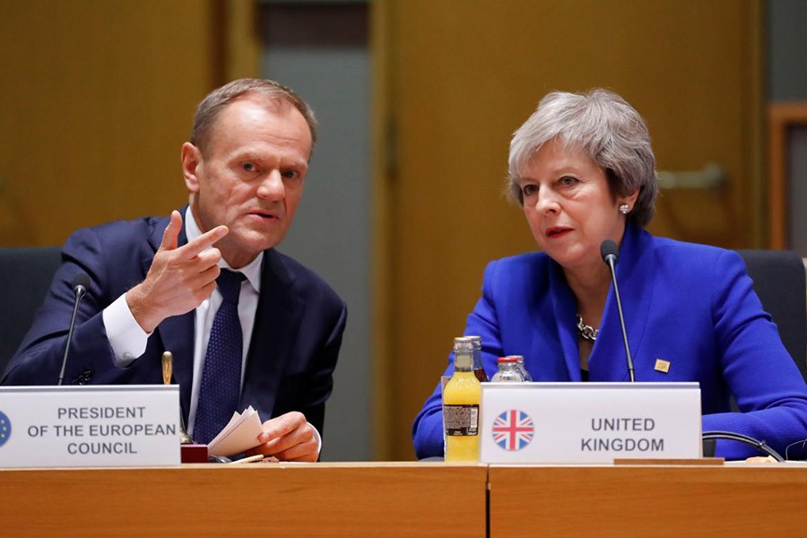 British Prime Minister Theresa May (R) and European Union Council President Donald Tusk during the extraordinary EU leaders summit to finalise and formalise the Brexit agreement in Brussels of Belgium on Sunday. -Reuters Photo