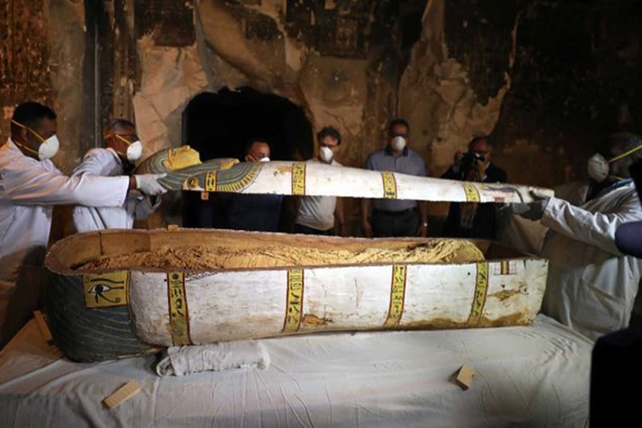 Archaeologists remove the cover of an intact sarcophagus inside the tomb TT33 in Luxor, Egypt, November 24, 2018. Reuters