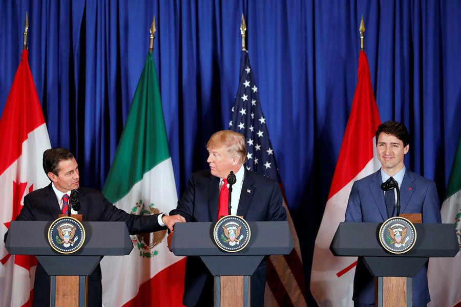 US President Donald Trump, Canadian Prime Minister Justin Trudeau and Mexican President Enrique Pena Nieto at the USMCA signing ceremony on Friday in Argentina. -Reuters Photo