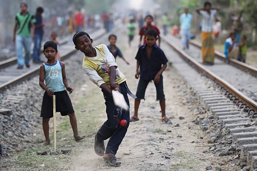 Bangladeshi children play cricket on railway tracks in Chittagong. Photo: Collected