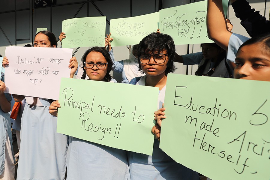 Students holding placards as they demo in front of the school. FE photo