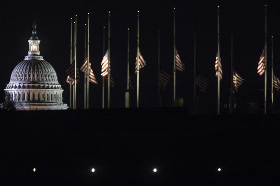 WASHINGTON: The flags surrounding the Washington Monument are at half-staff for the late President George HW Bush on Capitol Hill on Tuesday   	— New York Times