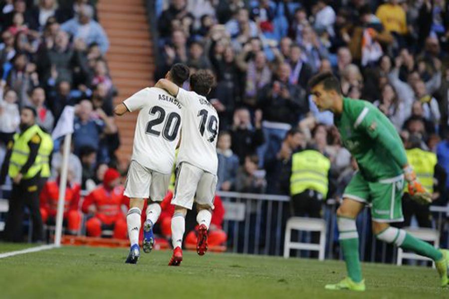 Real Madrid's Marco Asensio, left, celebrating with Alvaro Odriozola after scoring the opening goal during a round of 32, 2nd leg, Spanish Copa del Rey football match between Real Madrid and Melilla at the Santiago Bernabeu stadium at Madrid in Spain on Thursday	— AP