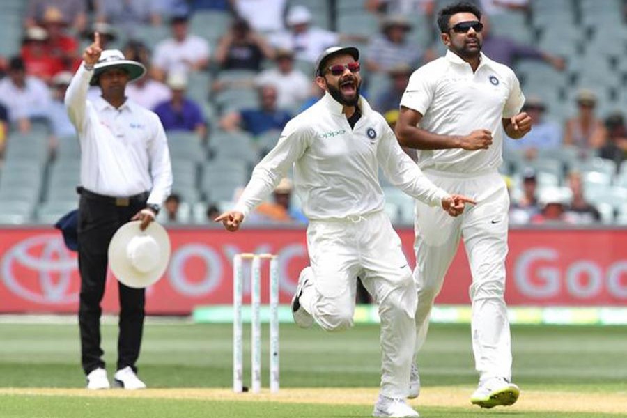 India's Virat Kohli and Ravichandran Ashwin celebrating after the dismissal of Marcus Harris of Australia during day two of the first Test against Australia at the Adelaide Oval on Friday	— Internet