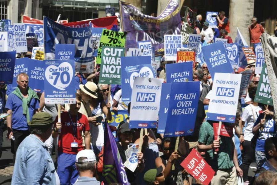 People march in central London to mark the 70th anniversary of the forming of the National Health Service (NHS) on June 30, 2018. Various unions and interested groups gathered to celebrate the forming of the NHS and call for better funding for the British health service. 	— Photo: AP