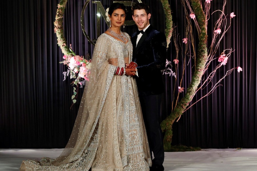 Bollywood actress Priyanka Chopra and her husband singer Nick Jonas arrive for a photo opportunity at their wedding reception in New Delhi, India, on December 4, 2018 - REUTERS/Adnan Abidi