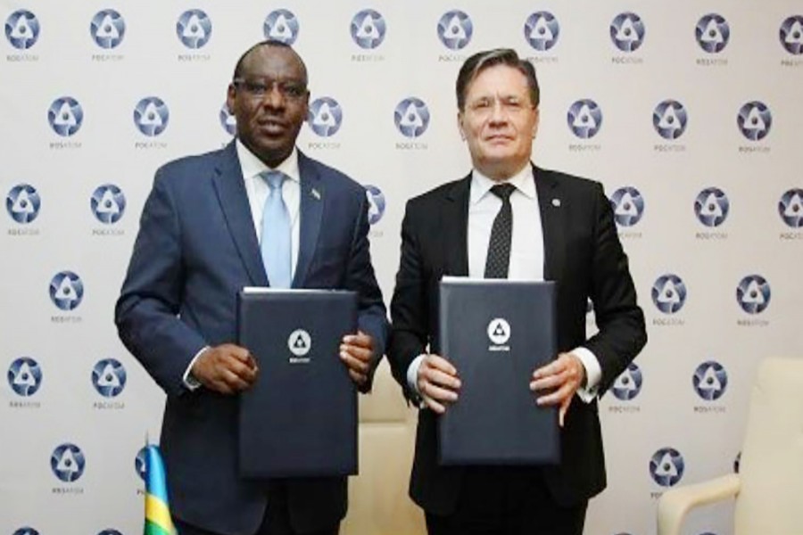 Rwandan Minister Claver Gatete (L) and Alexey Likhachev (R) pose for photograph after sigining and agreement in Moscow recently. Photo source: Rosatom