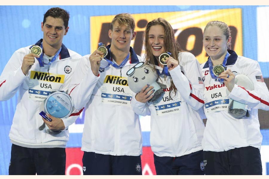 Gold medalist and new world record holders USA team, from left, Michael Andrew, Caeleb Dressel, Olivia Smoglia and Kelsi Dahlia posing during ceremony at the mixed 4x50m medley relay in the 14th FINA World Swimming Championships in Hangzhou in eastern China's Zhejiang Province on Thursday		 	— AP