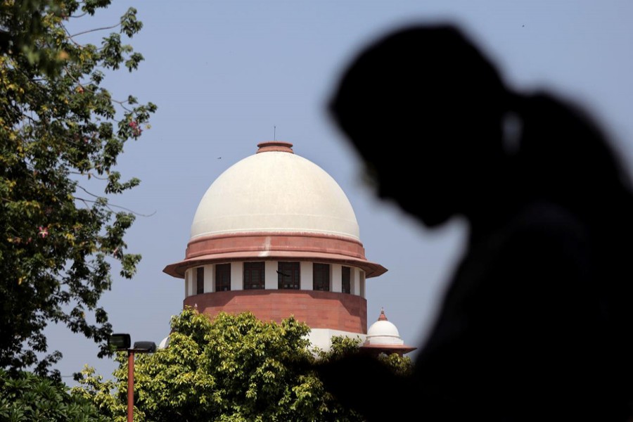 A woman checks her mobile phone inside the premises of the Supreme Court in New Delhi, September 28, 2018. Reuters/Files