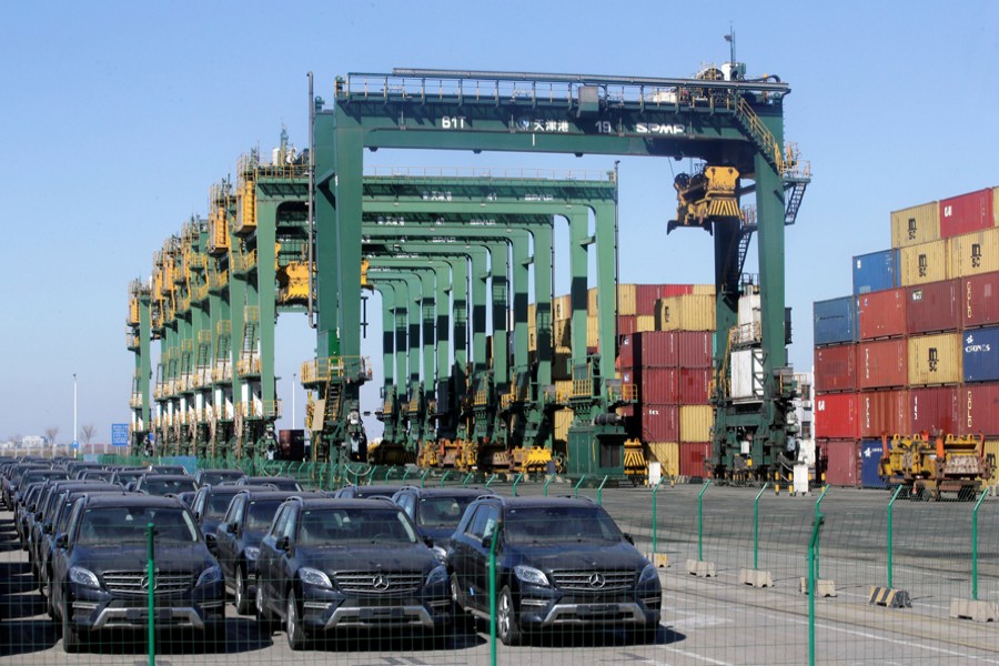 Imported Mercedes Benz cars are seen next to containers at Tianjin Port, in northern China February 23, 2017. Reuters/File Photo