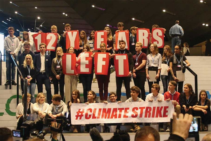 Members of civil society sing Michael Jackson's 'Earth Song' on the steps of the venue of COP24 Conference, reminding delegates that there are only 12 years left to limit global warming to 1.5°C