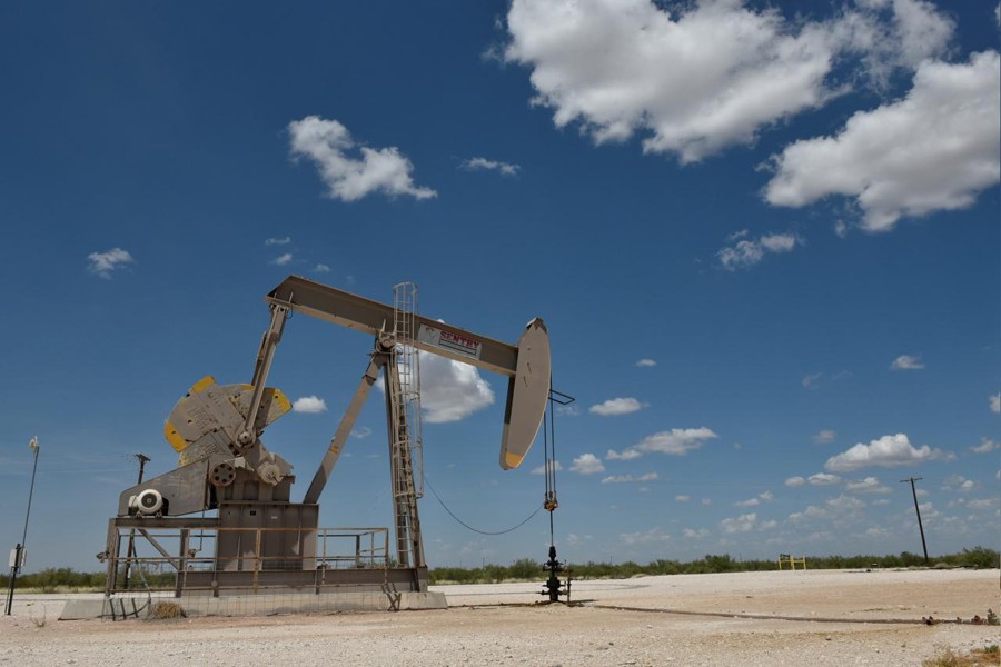 A pump jack operates in the Permian Basin oil production area near Wink, Texas, US, August 22, 2018. Reuters/Files