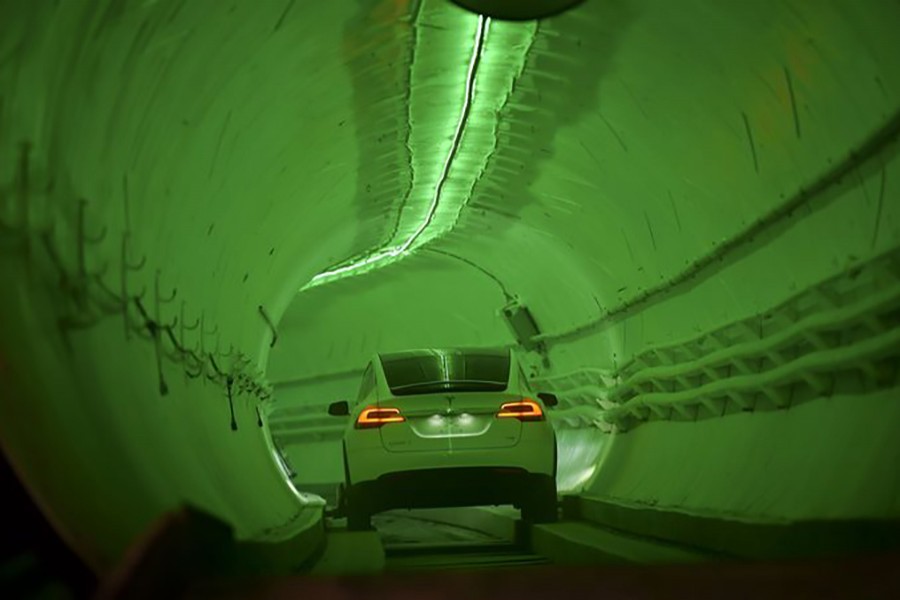 A modified Tesla Model X drives into the tunnel entrance before an unveiling event for the Boring Company. Photo: Collected