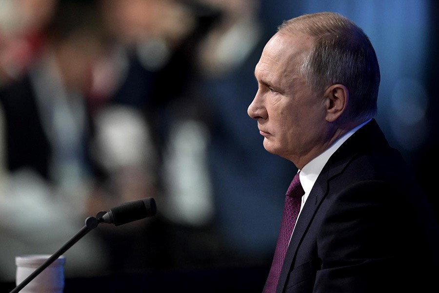 Russian President Vladimir Putin listening during annual news conference in Moscow on Thursday. -Reuters Photo