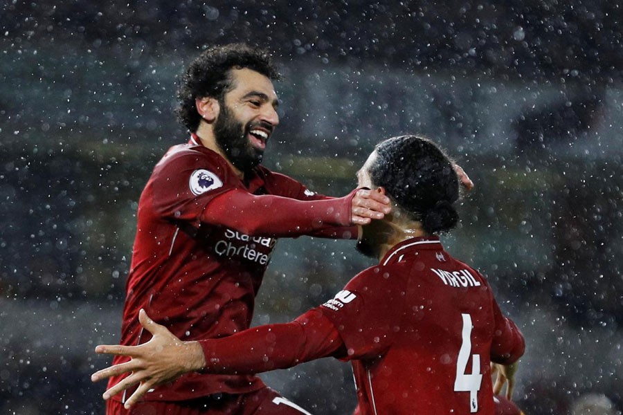 Soccer Football - Premier League - Wolverhampton Wanderers v Liverpool - Molineux Stadium, Wolverhampton, Britain - December 21, 2018 Liverpool's Mohamed Salah celebrates scoring their first goal with Virgil van Dijk - REUTERS/Darren Staples