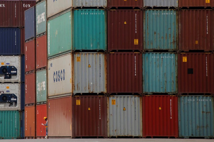 A labourer works in a container area at a port in Tokyo, Japan July 19, 2017. Reuters/Files