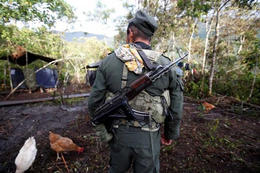 In this Reuters file photo, a member of the 51st Front of the Revolutionary Armed Forces of Colombia (FARC) walks at a camp in Cordillera Oriental, Colombia.