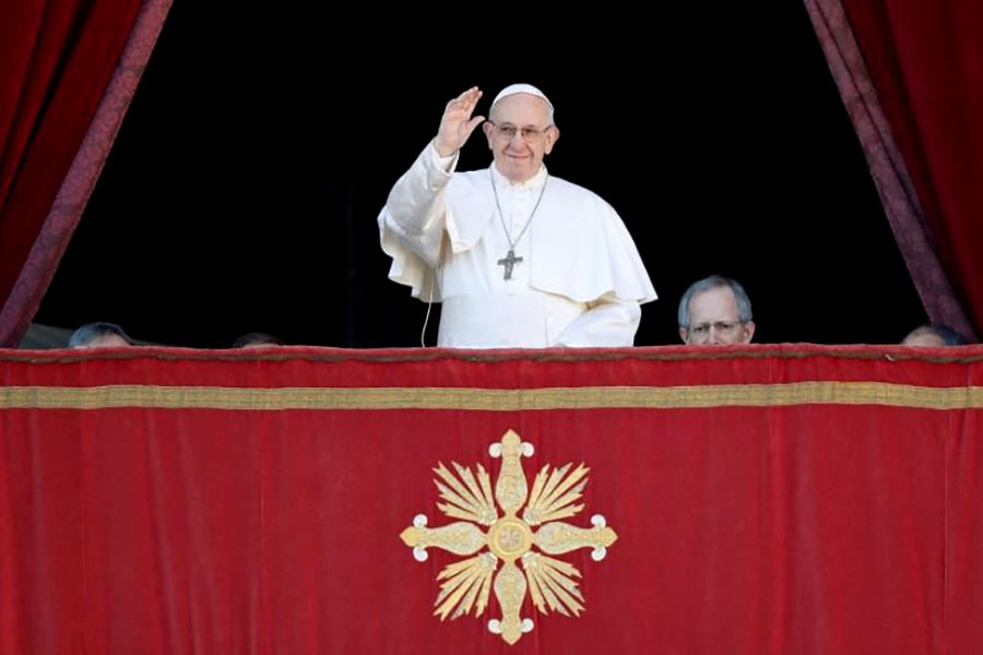 Pope Francis waving hand at the main balcony of Saint Peter's Basilica at the Vatican on Tuesday. -Reuters Photo