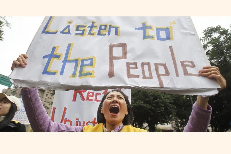 TAIPEI: A protester shouting slogans demanding tax reform outside the Ministry of Finance in Taipei on Thursday	— AP