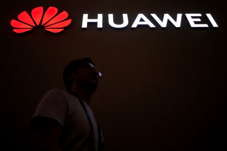 A man walks past a sign board of Huawei at CES (Consumer Electronics Show) Asia 2018 in Shanghai, China, June 14, 2018. Reuters/Files