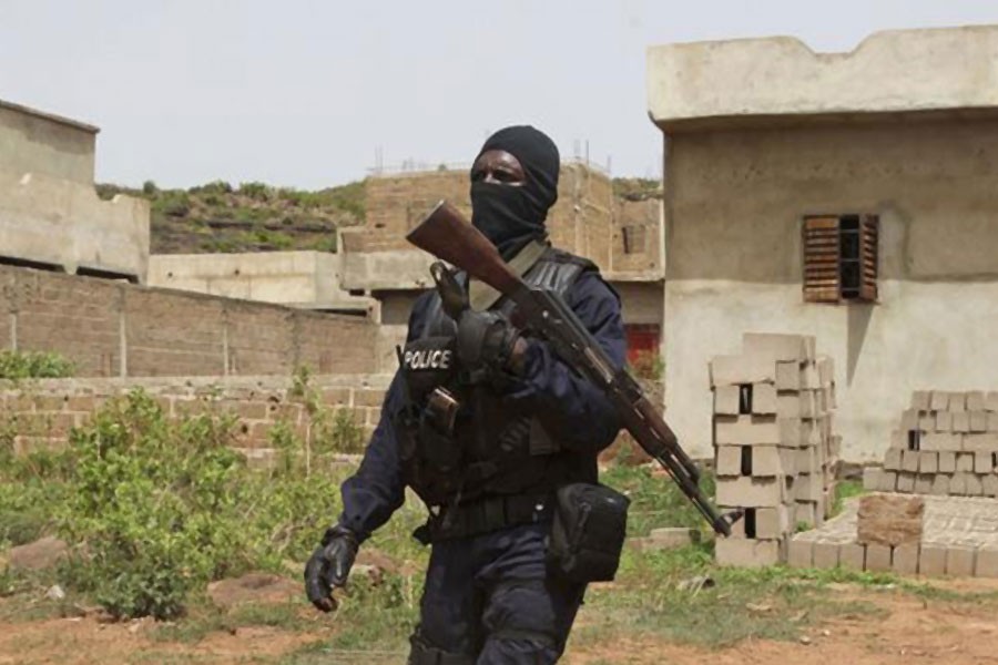 A Malian police officer patrols near Bamoko in this file photo from 2017 - AP