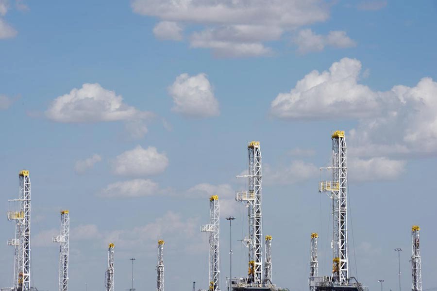 Oil rigs in a storage facility wait to be transported to the oil field in Midland, Texas US   	— Reuters