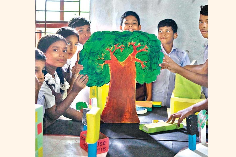 Students engaging in a design thinking activity related to tree plantation in Alokito Hridoy School in Tangail